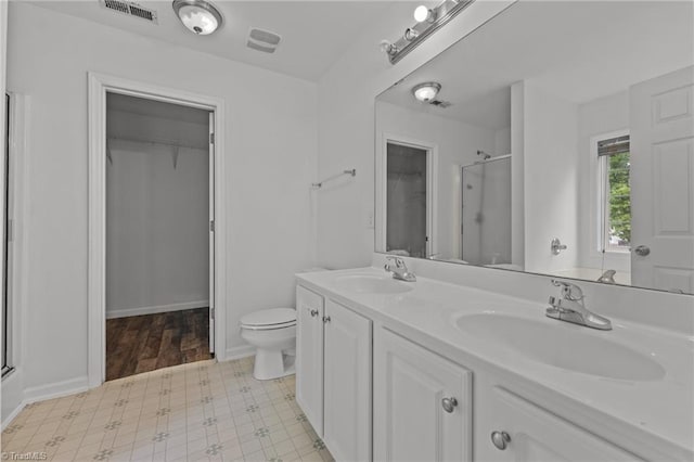 1310 Silver Dr, Mebane, NC 27302 - full bath featuring an enclosed shower, a spacious closet, double vanity, and toilet