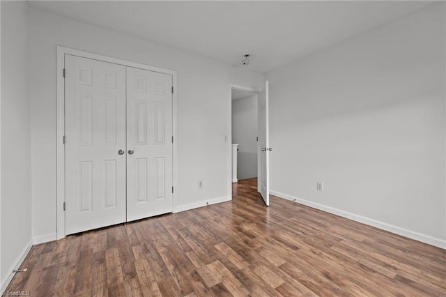 1310 Silver Dr, Mebane, NC 27302 - unfurnished bedroom with wood finished floors, baseboards, and a closet