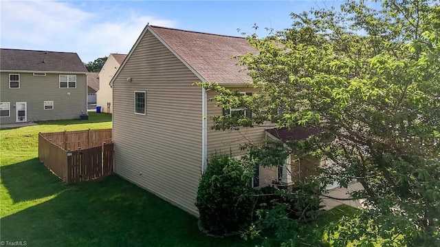 1310 Silver Dr, Mebane, NC 27302 - view of side of home with a lawn and a shingled roof