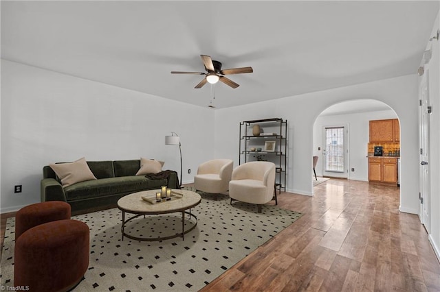 1310 Silver Dr, Mebane, NC 27302 - living area featuring arched walkways, a ceiling fan, wood finished floors, and baseboards