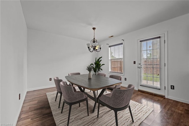 1310 Silver Dr, Mebane, NC 27302 - dining area featuring a chandelier, dark wood-type flooring, and baseboards