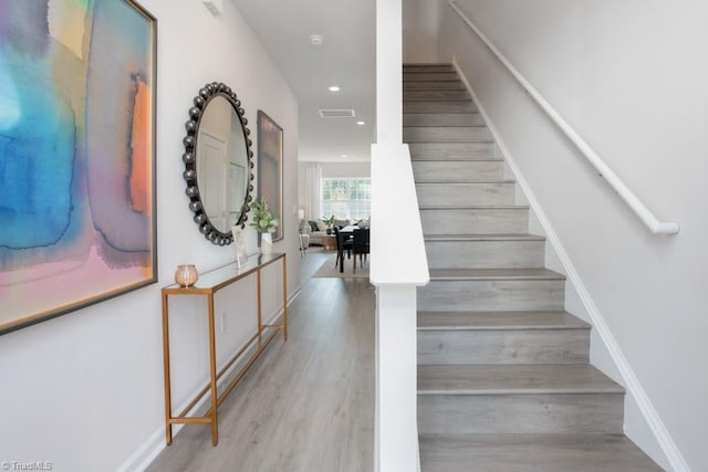 stairs featuring hardwood / wood-style flooring