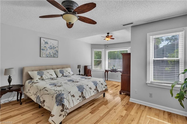408 Camelot Dr, Salisbury, NC 28144 - bedroom featuring a textured ceiling, light wood-style floors, and a ceiling fan