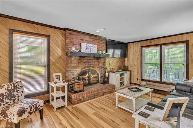 408 Camelot Dr, Salisbury, NC 28144 - living room with wood walls, ornamental molding, a brick fireplace, and wood finished floors