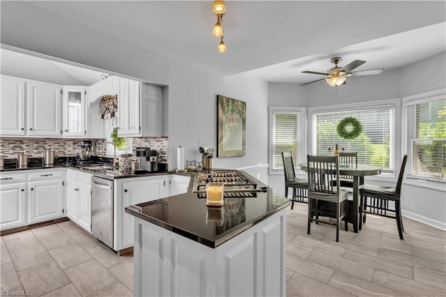 408 Camelot Dr, Salisbury, NC 28144 - kitchen featuring appliances with stainless steel finishes, dark countertops, decorative backsplash, and ceiling fan