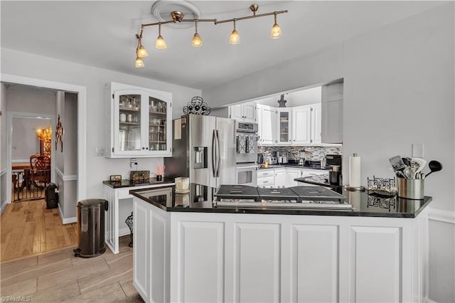 408 Camelot Dr, Salisbury, NC 28144 - kitchen with appliances with stainless steel finishes, dark countertops, white cabinets, and glass insert cabinets