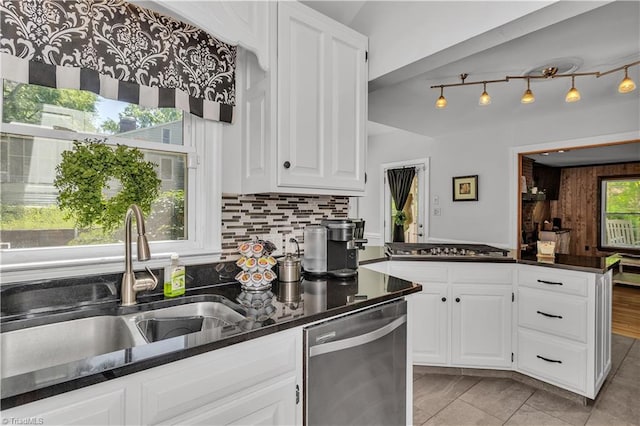 408 Camelot Dr, Salisbury, NC 28144 - kitchen with appliances with stainless steel finishes, backsplash, white cabinets, a peninsula, and dark stone counters