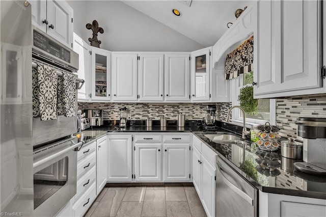 408 Camelot Dr, Salisbury, NC 28144 - kitchen featuring appliances with stainless steel finishes, vaulted ceiling, tasteful backsplash, white cabinetry, and recessed lighting