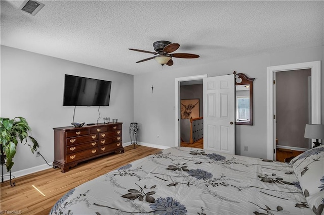 408 Camelot Dr, Salisbury, NC 28144 - bedroom featuring a textured ceiling, wood finished floors, and ceiling fan