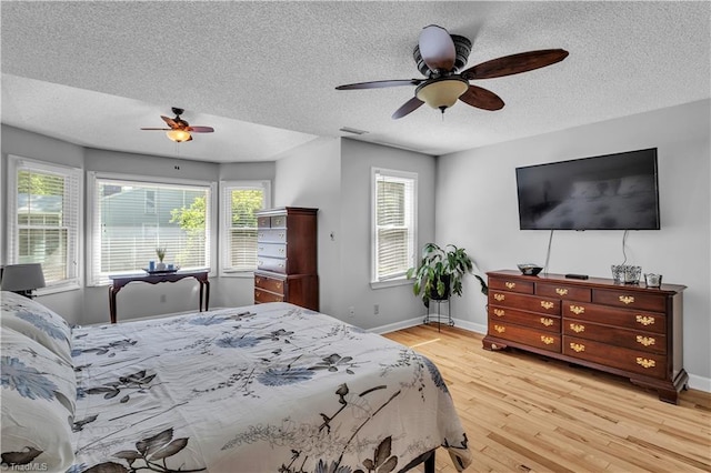 408 Camelot Dr, Salisbury, NC 28144 - bedroom featuring a textured ceiling, wood finished floors, multiple windows, and a ceiling fan