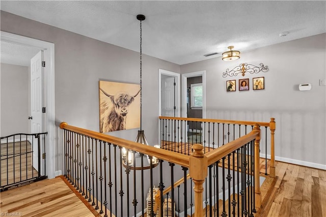 408 Camelot Dr, Salisbury, NC 28144 - corridor featuring an upstairs landing, wood finished floors, and a textured ceiling