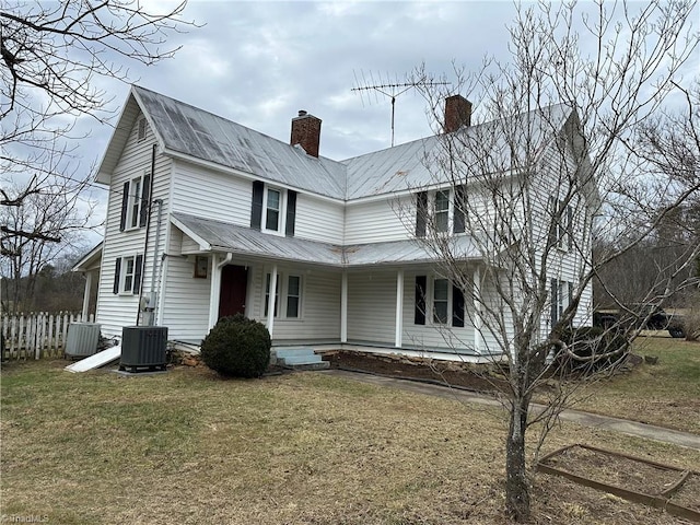 exterior space featuring central AC, covered porch, and a front lawn