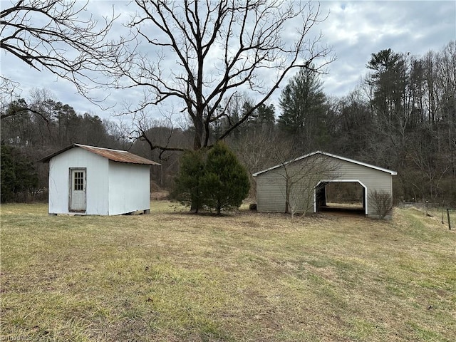 view of yard with a carport and a shed