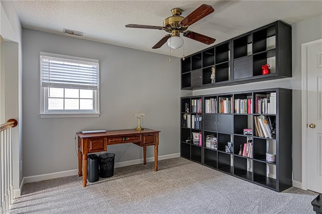 home office with ceiling fan, a textured ceiling, and carpet flooring