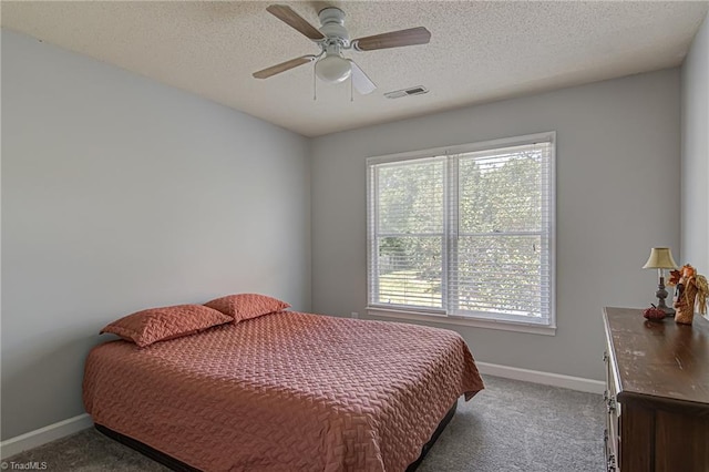 carpeted bedroom with a textured ceiling and ceiling fan