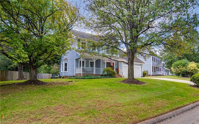 view of front facade featuring a front yard, a garage, and covered porch