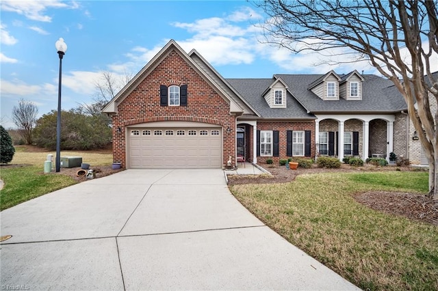 view of front of property featuring an attached garage, a shingled roof, a front lawn, concrete driveway, and brick siding