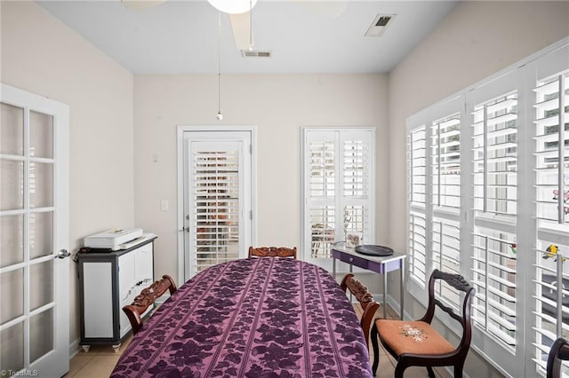 tiled bedroom with visible vents and a ceiling fan