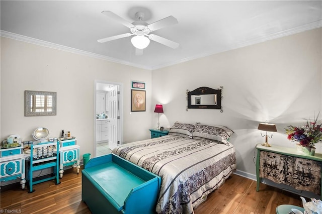 bedroom with connected bathroom, baseboards, wood finished floors, and crown molding