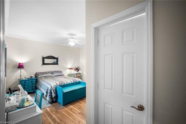 bedroom featuring a ceiling fan and wood finished floors