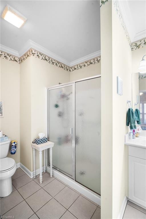 bathroom with crown molding, toilet, tile patterned floors, and a shower stall