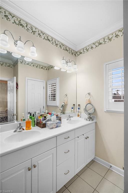 full bath featuring double vanity, tile patterned flooring, ornamental molding, and a sink