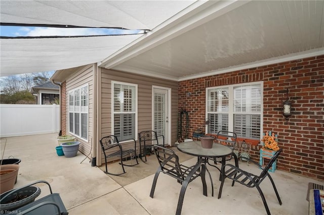 view of patio / terrace featuring outdoor dining area and fence