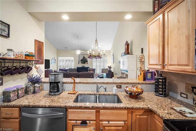 kitchen with lofted ceiling, light stone counters, decorative backsplash, stainless steel appliances, and a sink