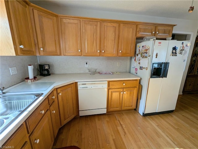 kitchen featuring decorative backsplash, sink, white appliances, and light wood-type flooring