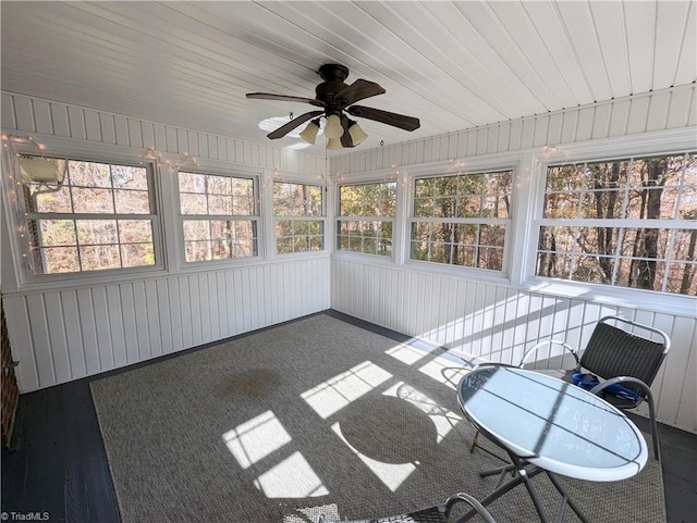 unfurnished sunroom featuring ceiling fan