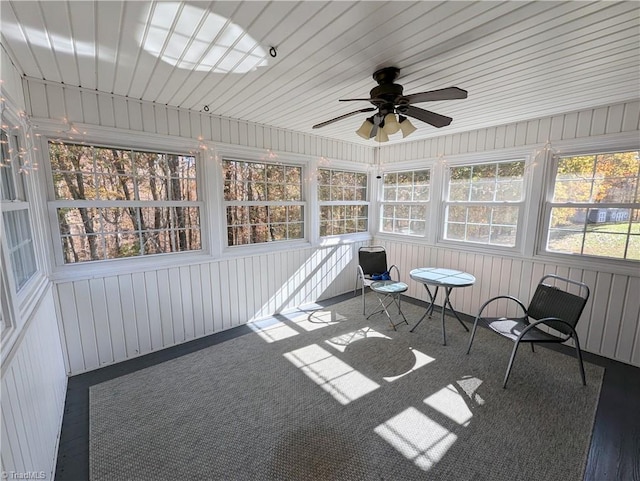 unfurnished sunroom featuring ceiling fan