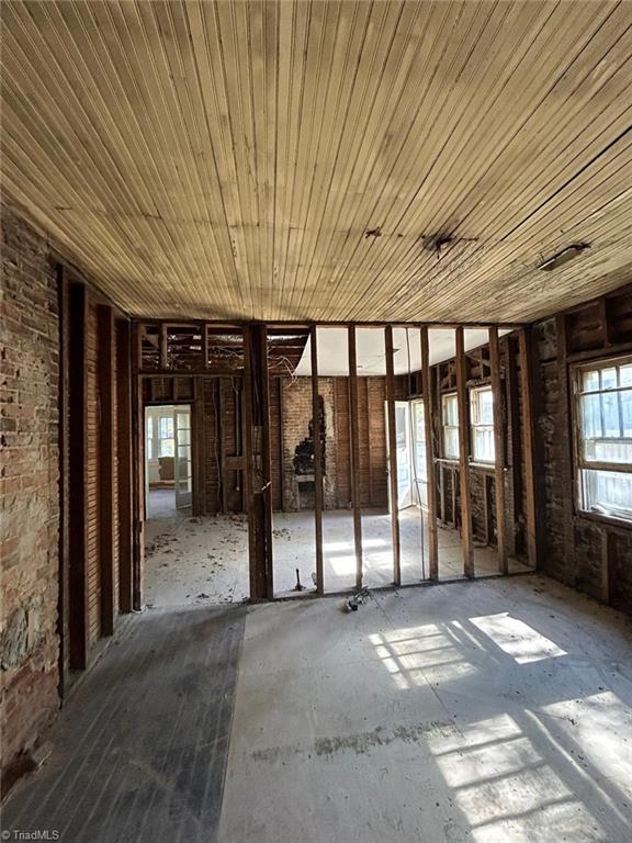 misc room with ceiling fan, wood ceiling, and plenty of natural light