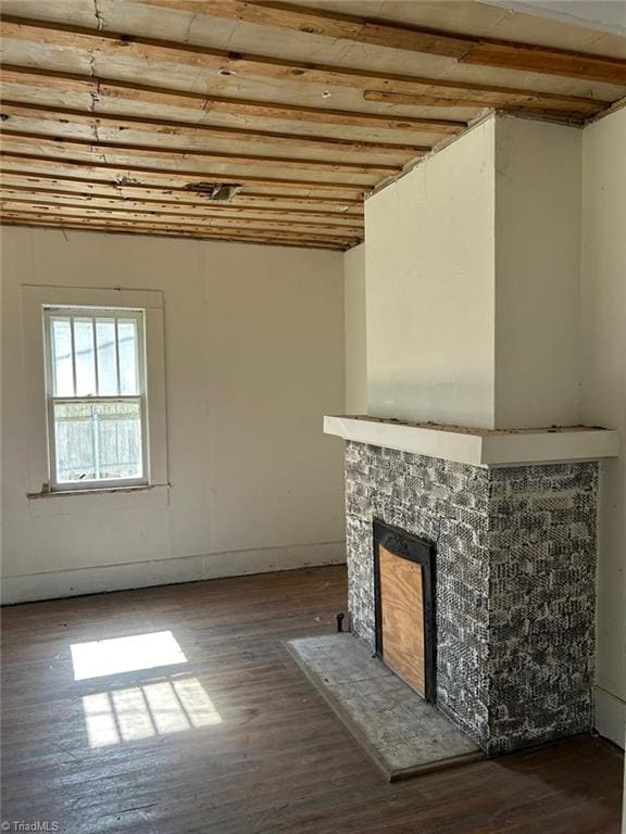 unfurnished living room with lofted ceiling, dark hardwood / wood-style flooring, and a fireplace