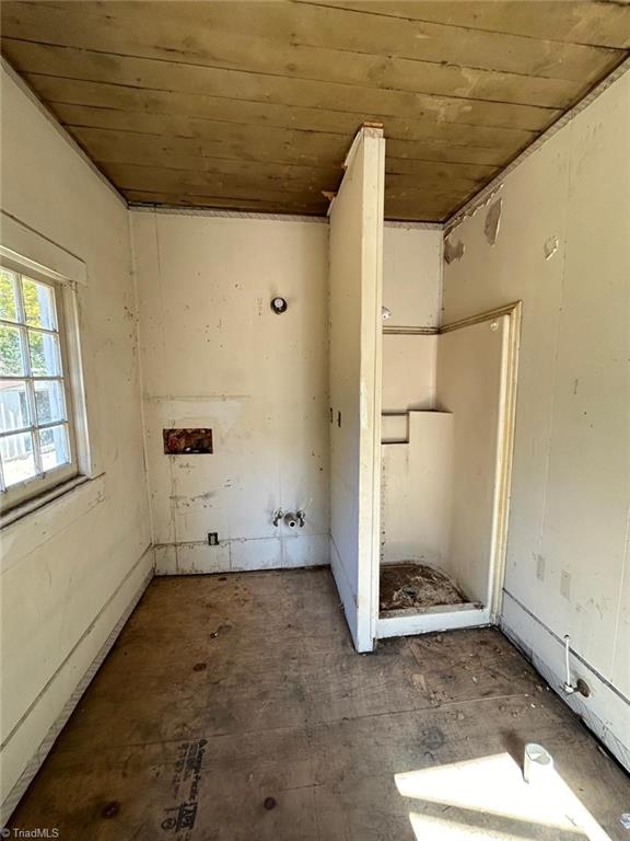 laundry area featuring wooden ceiling