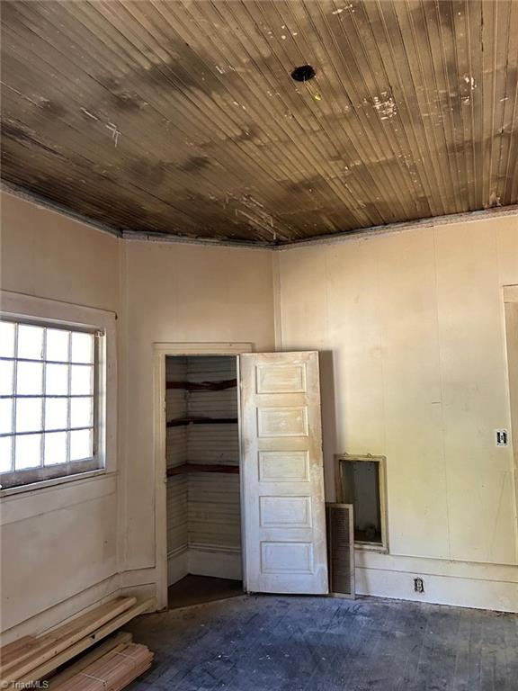 empty room with wood ceiling