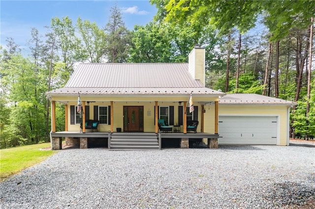 3080 Shiloh Church Rd, Winston-Salem, NC 27105 - view of front of home featuring covered porch, a chimney, metal roof, and a garage