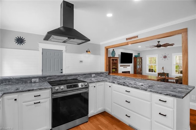 3080 Shiloh Church Rd, Winston-Salem, NC 27105 - kitchen featuring stainless steel electric range, island exhaust hood, light wood-type flooring, dark stone counters, and recessed lighting
