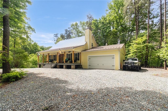 3080 Shiloh Church Rd, Winston-Salem, NC 27105 - view of front of house with a porch, an attached garage, metal roof, a chimney, and driveway