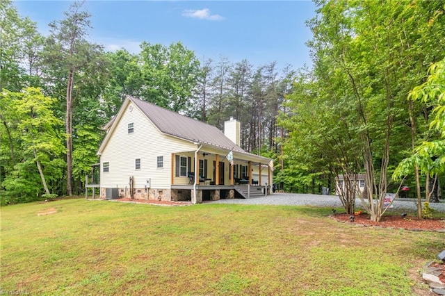 3080 Shiloh Church Rd, Winston-Salem, NC 27105 - view of side of property featuring covered porch, a chimney, a yard, central AC unit, and metal roof