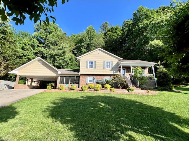 split level home featuring a front lawn and a carport