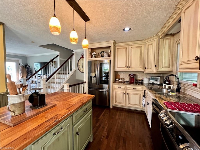 kitchen with dark hardwood / wood-style flooring, hanging light fixtures, stove, stainless steel fridge, and wooden counters