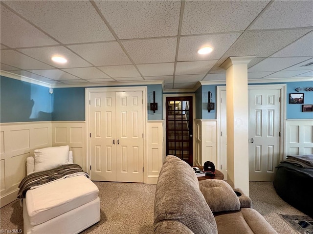 interior space featuring a paneled ceiling and decorative columns