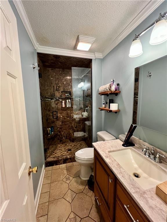 bathroom with vanity with extensive cabinet space, toilet, a tile shower, tile flooring, and a textured ceiling