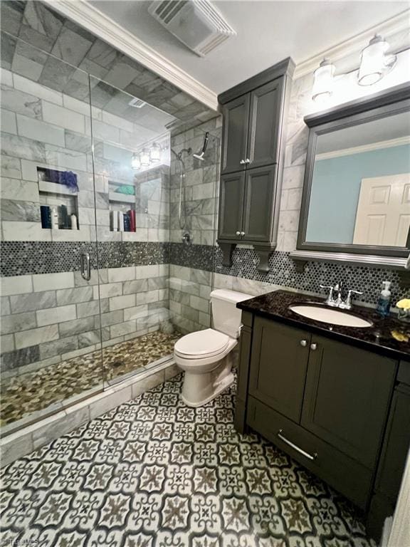 bathroom featuring tile flooring, ornamental molding, and vanity with extensive cabinet space