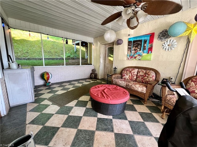 sunroom with a wealth of natural light, wooden ceiling, and ceiling fan