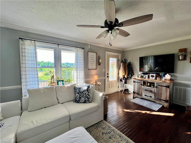 living room featuring dark wood-type flooring, ceiling fan, a textured ceiling, and crown molding