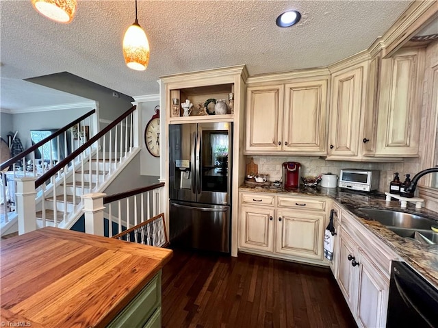 kitchen featuring stainless steel fridge with ice dispenser, dark wood-type flooring, hanging light fixtures, cream cabinets, and backsplash