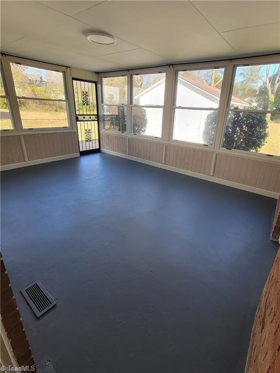 unfurnished sunroom with plenty of natural light and visible vents