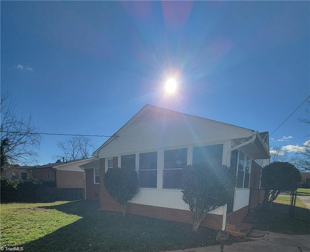 view of home's exterior featuring a yard and fence