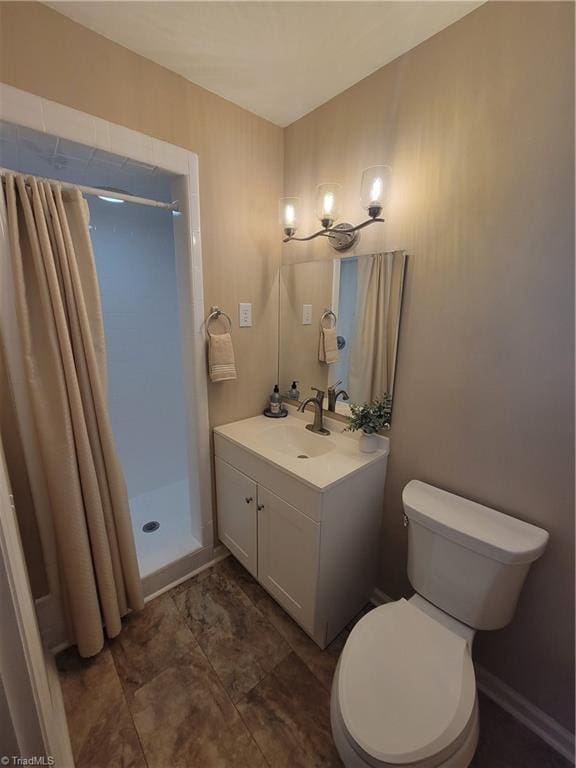 full bathroom featuring vanity, toilet, and a shower stall